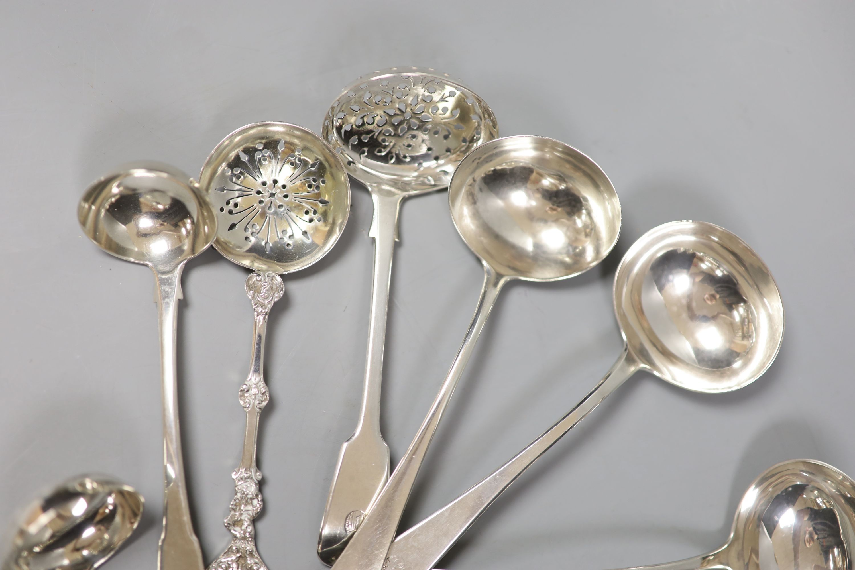 Eleven assorted 19th century and later silver suace and sifter ladles, various dates and makers, 13.5oz.